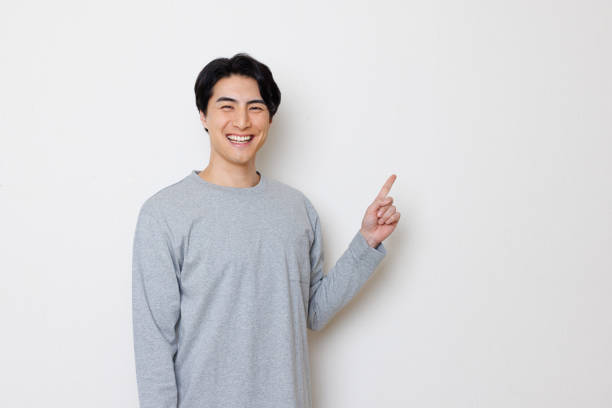 istock Japanese man smiling and pointing 1493430815