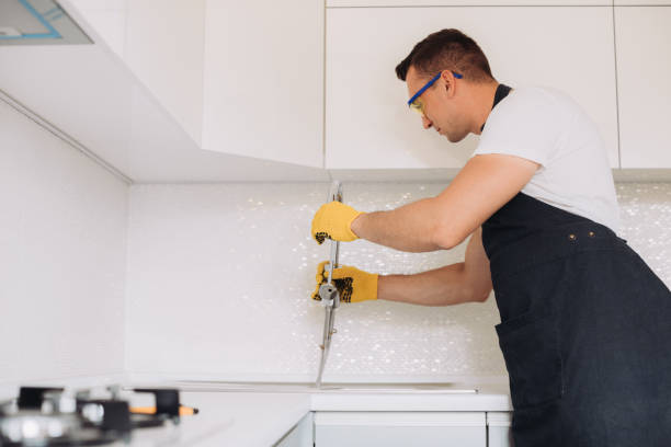istock Maintenance man installing plumbing equipment in the kitchen 1493430863