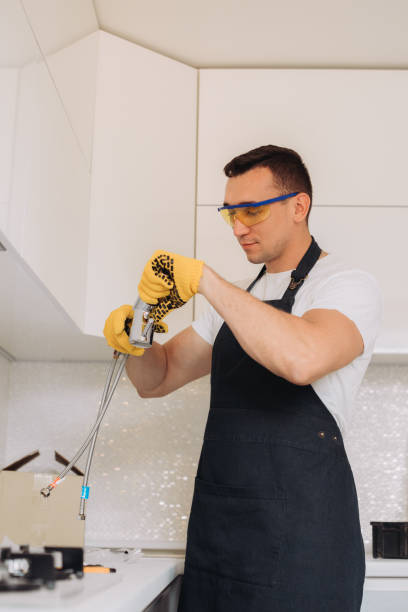istock Maintenance man is going to install  plumbing equipment in the kitchen 1493430885
