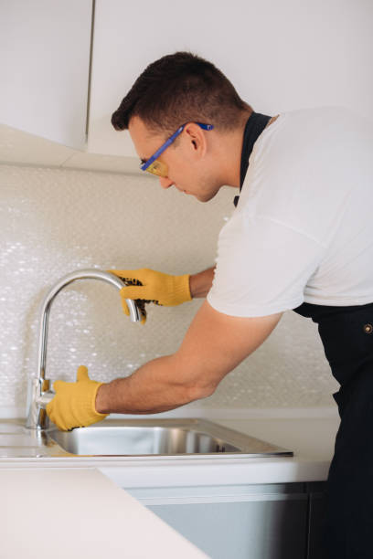 istock Maintenance man installing plumbing equipment in the kitchen 1493431142