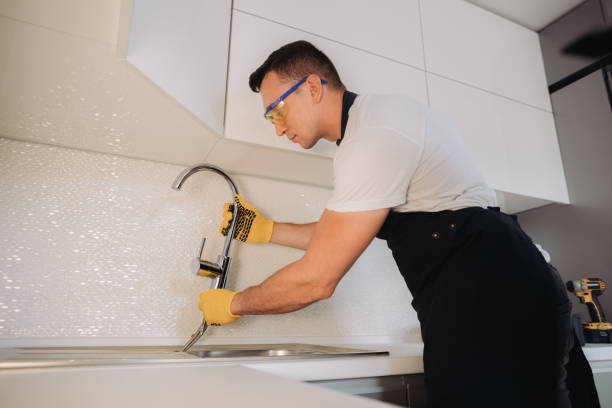 istock Maintenance man installing plumbing equipment in the kitchen 1493431144