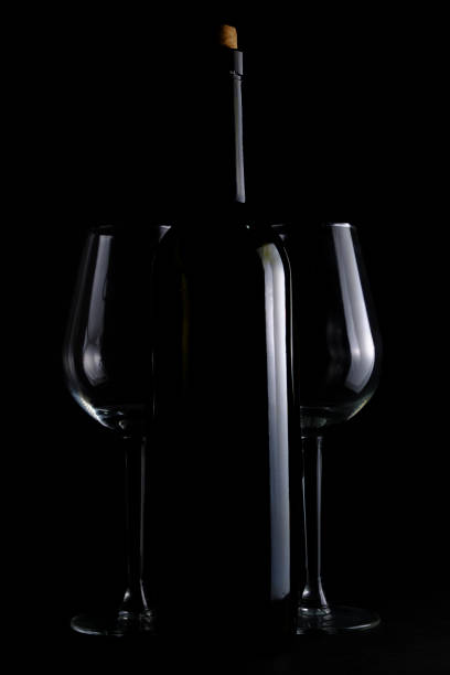 istock Bottle of wine and two wine glasses black background. 1493431617