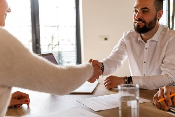 istock Interviewer and a interviewee shaking hands at the beginning of a job interview meeting 1493432485