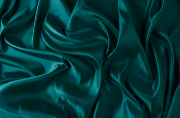 istock Silk fabric, abstract wavy green satin fabric background. 1493436145