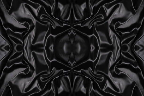 istock Silk fabric, abstract wavy black satin fabric background. 1493436149