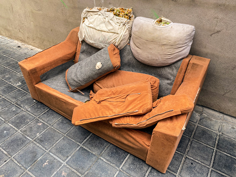 High angle view of broken sofa left in the street in the city of Valencia, Spain