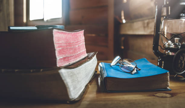 istock eyeglass on blue holy Bible with window light in morning. 1493440278