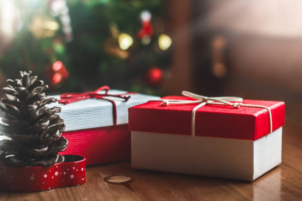 istock Two gift box on wooden table at Christmas tree background.Christmas concept 1493440333