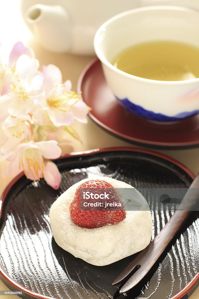 Japanese confectionery Strawberry Daifuku with flower and green tea Daifuku Mochi Stock Photo