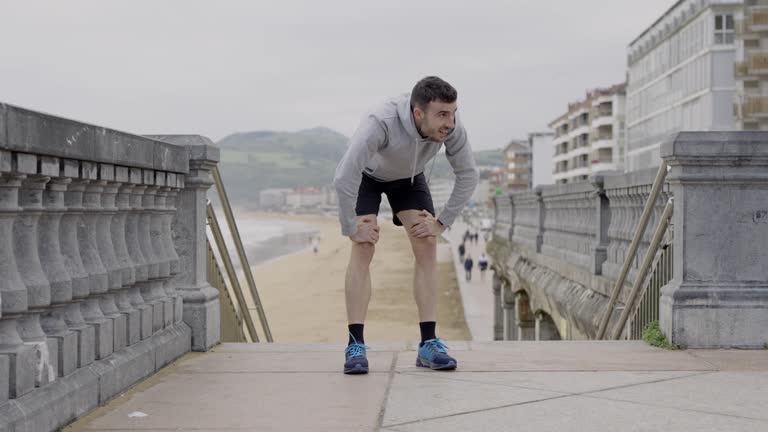 Exhausted sportsman after running up on stairs