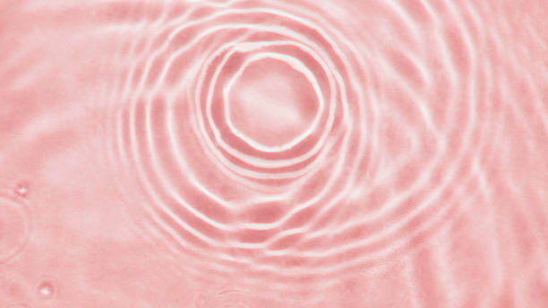 istock Abstract textured background, water waves in the pool with sun reflection, clear pink water 1493443070
