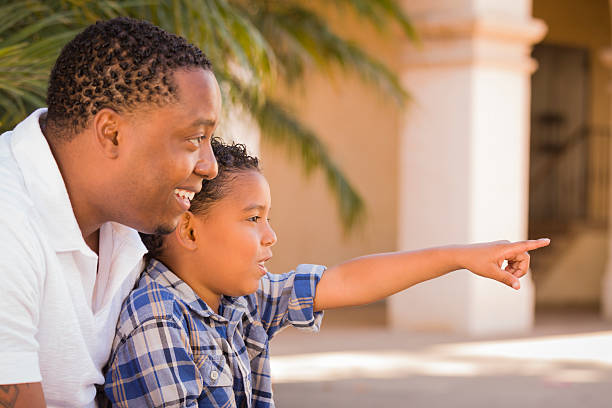 istock Mixed Race Father and Son Pointing in the Park 149344330