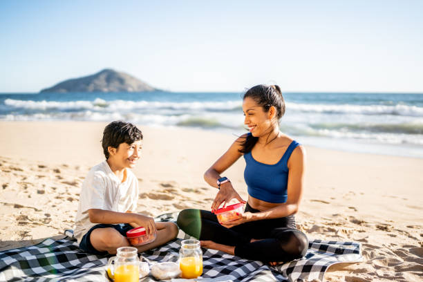 istock Mother and son having a picnic on the beach 1493445719