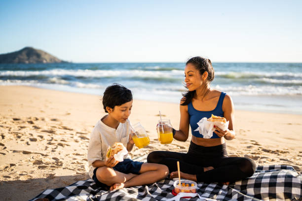 istock Mother and son having a picnic on the beach 1493445730