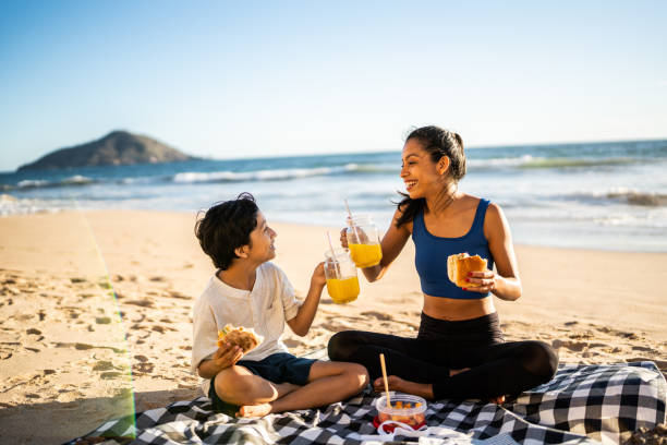 istock Mother and son having a picnic on the beach 1493445731