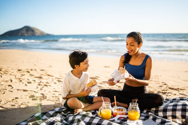 istock Mother and son having a picnic on the beach 1493445736