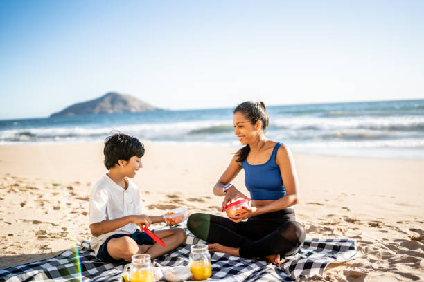 istock Mother and son having a picnic on the beach 1493445739
