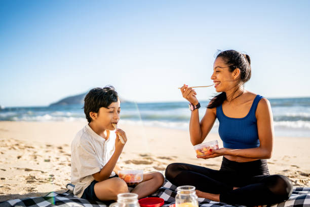 istock Mother and son having a picnic on the beach 1493445744