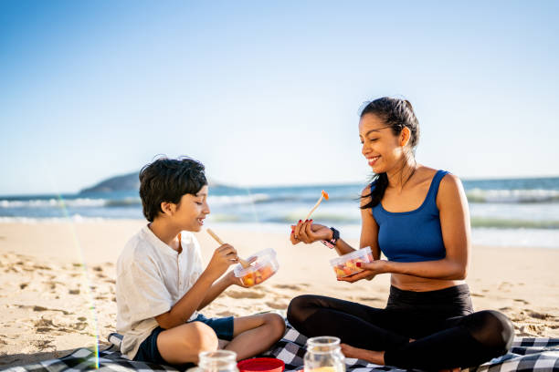 Mother and son having a picnic on the beach