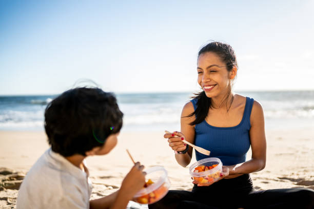 istock Mother and son having a picnic on the beach 1493445768