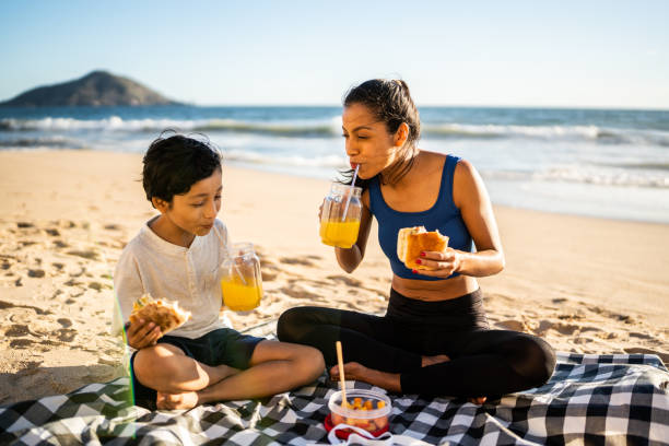 istock Mother and son having a picnic on the beach 1493446142