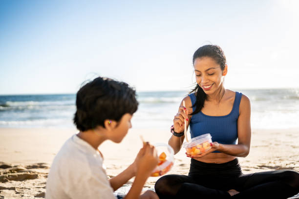 istock Mother and son having a picnic on the beach 1493446283