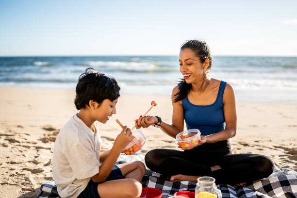 istock Mother and son having a picnic on the beach 1493446288