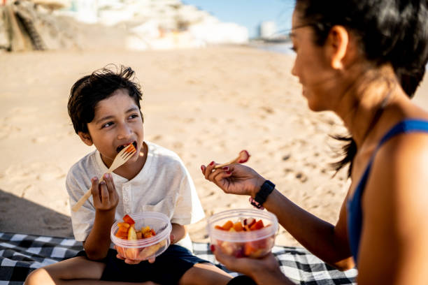 istock Mother and son having a picnic on the beach 1493446292
