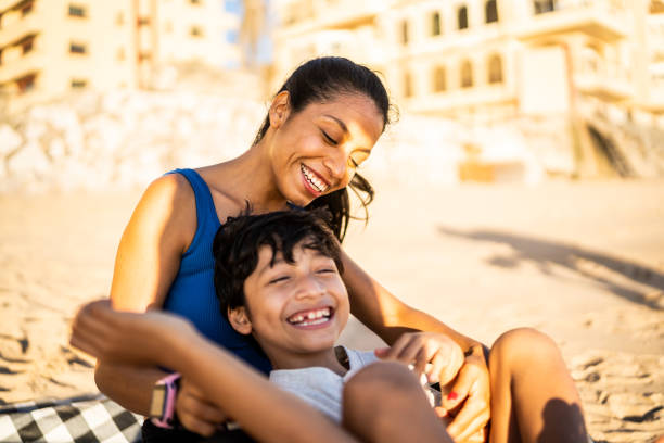 istock Mother and son having fun on the beach 1493446332