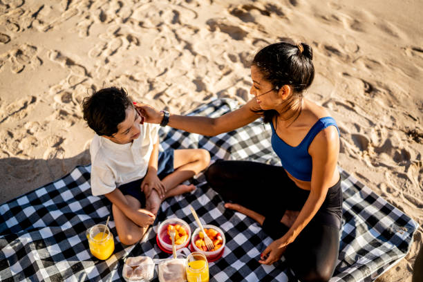 istock Mother and son having a picnic on the beach 1493446342