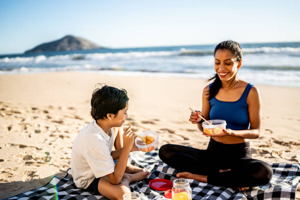 istock Mother and son having a picnic on the beach 1493446343