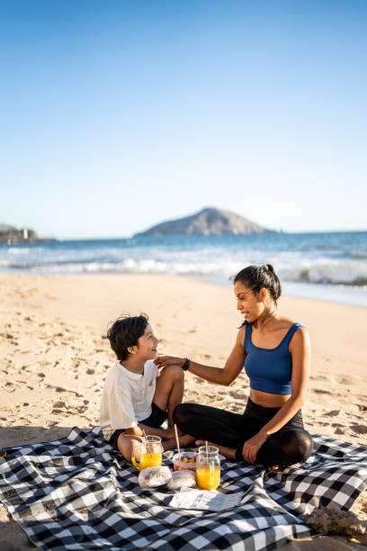 istock Mother and son having a picnic on the beach 1493446397