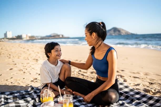 istock Mother and son having a picnic on the beach 1493446403