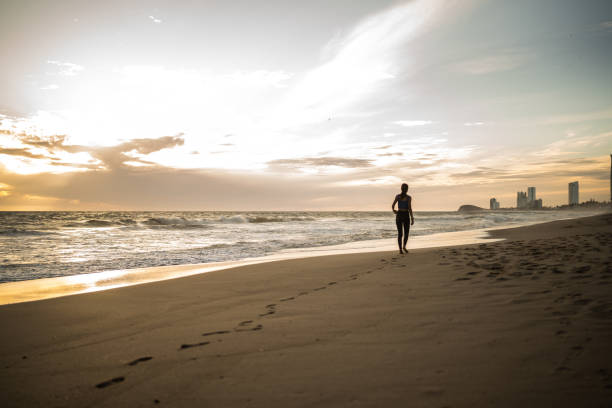 Young woman walking on the beach