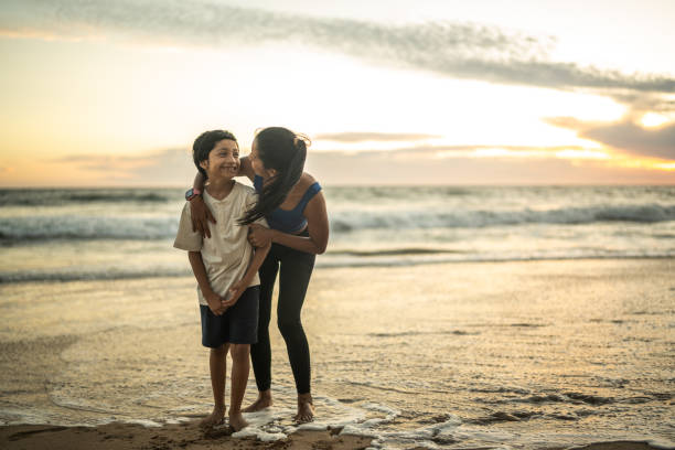 istock Mother and son embracing on the beach 1493446677