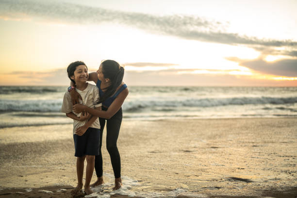 istock Mother and son embracing on the beach 1493446696