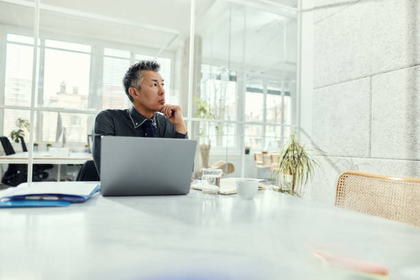 istock Thoughtful Asian businessman working in the office. 1493446802