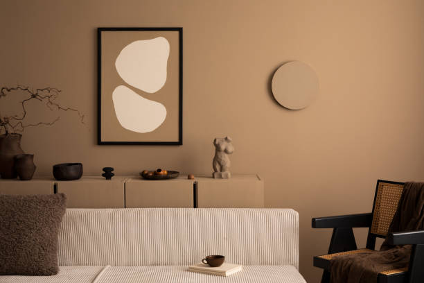 istock Creative composition of warm living room interior with mock up poster frame, modular sofa, rattan armchair, brown sideboard, book, boucle pillow and personal accessories. Home decor. Template. 1493446936