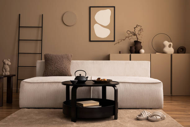 istock Warm and cozy living room interior with mock up poster frame, modular sofa, black coffee table, ladder, beige rug, vase with branch, sculpture, slippers and personal accessories. Home decor. Template. 1493446994