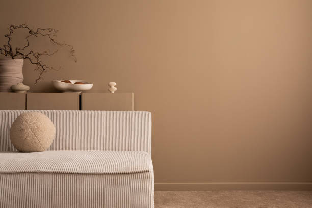 istock Minimalist composition of aesthetic living room interior with copy space, modular sofa, brown sideboard, vase with branch, round pillow and personal accessories. Home decor. Template. 1493447065