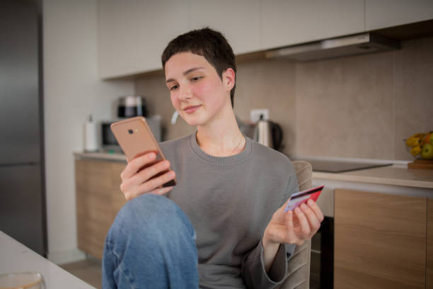 istock Happy young customer enjoys shopping online 1493447357