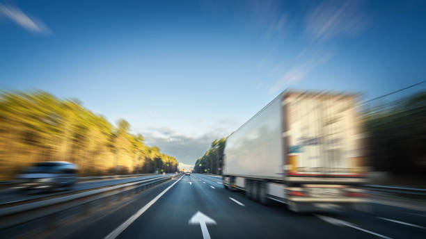 istock Heavy Semi Truck at highway, blurred in motion 1493448682