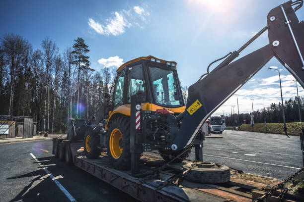 istock Tractor on the trailer of a construction machinery transporter 1493448979