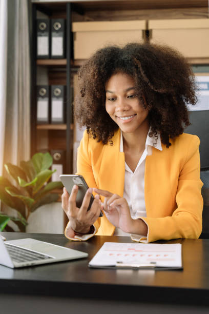 istock Happy black businesswoman using a smartphone play social in a creative office. 1493449372