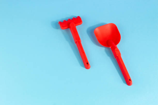 istock Beach red shovel and rake summer banner flat lay on blue background 1493449893