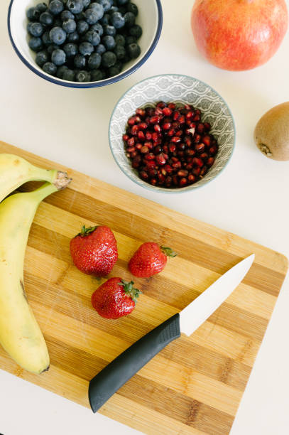istock Ripe strawberries and banana for smoothie on cutting board 1493452031