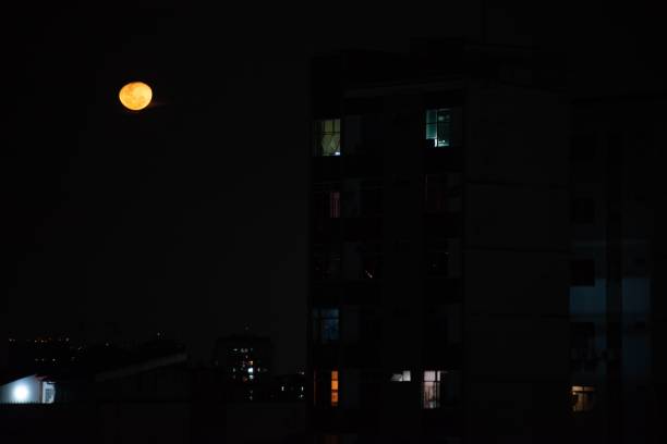 istock Luminous full moon casts a romantic glow over a bustling downtown cityscape in the evening 1493454561