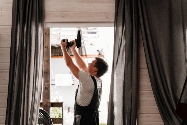 istock A repairman repairs or adjusts window frames or glass doors on the terrace. 1493454722