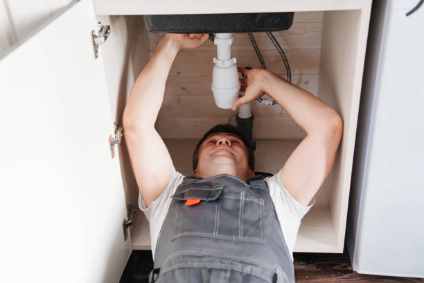 istock The plumber disassembles the siphon under the sink to clear the blockage. 1493456140
