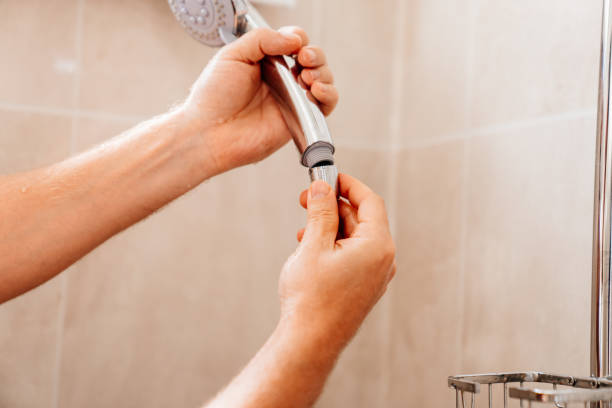 istock A master plumber collects a shower head in the bathroom. 1493456670